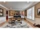 Bright dining room with hardwood floors, neutral colors, an area rug, and a dark wood table with chairs at 8070 Georgetown Cir, Suwanee, GA 30024