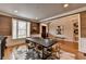 Dining room with dark wood table, light colored chairs, hardwood floors, decorative rug and large window at 8070 Georgetown Cir, Suwanee, GA 30024