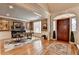 Open foyer with hardwood floors, area rugs, stylish front door and elegant light fixtures at 8070 Georgetown Cir, Suwanee, GA 30024