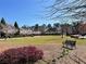 Picturesque community green space with manicured lawn and blooming trees for recreation and relaxation at 8070 Georgetown Cir, Suwanee, GA 30024