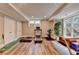 Home gym featuring workout equipment, hardwood floors, and natural light from windows at 8070 Georgetown Cir, Suwanee, GA 30024