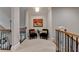 Hallway features seating, carpeted floors, and a view overlooking the floor below through metal railings at 8070 Georgetown Cir, Suwanee, GA 30024