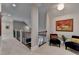 Upper hallway area featuring art, soft carpet, accent chairs, and railing overlooking the floor below at 8070 Georgetown Cir, Suwanee, GA 30024