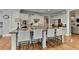 This open kitchen features stainless steel appliances and a large island with bar seating, great for entertaining at 8070 Georgetown Cir, Suwanee, GA 30024