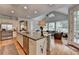 Open concept kitchen with a large center island, stainless steel appliances, and seamless flow to the living area at 8070 Georgetown Cir, Suwanee, GA 30024