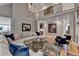 Spacious living room with high ceilings, a large sectional couch, hardwood floors and staircase view at 8070 Georgetown Cir, Suwanee, GA 30024
