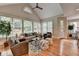 Sun-filled living room boasts hardwood floors, high ceilings, and a view of the lush, green outdoors at 8070 Georgetown Cir, Suwanee, GA 30024