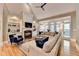 Bright living room with a fireplace, hardwood flooring, built-in shelving and comfortable seating area at 8070 Georgetown Cir, Suwanee, GA 30024