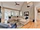 Living room showcasing a sectional sofa, hardwood floors, a fireplace, and an open floor plan at 8070 Georgetown Cir, Suwanee, GA 30024