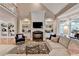 Living room with a cozy fireplace, hardwood flooring, built-in shelving and a comfortable sectional at 8070 Georgetown Cir, Suwanee, GA 30024