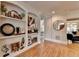 Bright living room features hardwood floors, built-in shelves, and an arched entry at 8070 Georgetown Cir, Suwanee, GA 30024