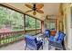 Cozy screened porch with comfortable seating, ceiling fans and views of the landscaped yard at 8070 Georgetown Cir, Suwanee, GA 30024
