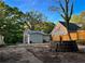 Backyard featuring a retaining wall between an empty lot and the home, trees, and a wooden fence at 2022 Detroit Ave, Atlanta, GA 30314