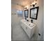 Elegant bathroom featuring a double vanity with modern sinks, large mirrors, and stylish lighting fixtures at 2022 Detroit Ave, Atlanta, GA 30314