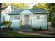 Cozy home featuring a light blue exterior, well-maintained lawn, and inviting entryway at 2022 Detroit Ave, Atlanta, GA 30314
