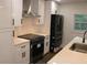 Stylish kitchen boasts white cabinets, stainless steel appliances, and modern finishes at 2022 Detroit Ave, Atlanta, GA 30314