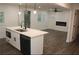 Modern kitchen opens to a living room featuring a fireplace and hardwood floors at 2022 Detroit Ave, Atlanta, GA 30314