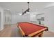 Basement entertainment area includes glass enclosed room, red pool table and wet bar at 5395 Lacosta Ln, Alpharetta, GA 30022