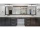 Modern bathroom featuring double vanity, granite countertop, and a large mirror reflecting a glass enclosed walk-in shower at 5395 Lacosta Ln, Alpharetta, GA 30022