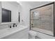 Updated bathroom featuring a tub and shower, vanity, and modern fixtures at 5395 Lacosta Ln, Alpharetta, GA 30022