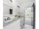Bright bathroom boasts double vanity, modern fixtures, and stylish tile floors at 5395 Lacosta Ln, Alpharetta, GA 30022