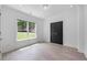 Bright bedroom featuring a large window and ample natural light on wood floors at 5395 Lacosta Ln, Alpharetta, GA 30022