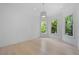 Bright bedroom with three large windows providing a view of the mature landscape at 5395 Lacosta Ln, Alpharetta, GA 30022