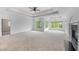 Spacious main bedroom with tray ceiling, fireplace, carpet and lots of windows at 5395 Lacosta Ln, Alpharetta, GA 30022