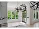 Bright breakfast nook featuring globe lighting, an exterior view, and access to the outdoor living space at 5395 Lacosta Ln, Alpharetta, GA 30022