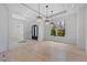 Spacious dining room with modern light fixture, a view of the grounds, and open access to other living spaces at 5395 Lacosta Ln, Alpharetta, GA 30022