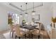 Elegant dining room with stylish chandeliers, a marble table, and seating for six at 5395 Lacosta Ln, Alpharetta, GA 30022