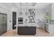 Modern kitchen with sleek black and white design, stainless steel appliances, and a large center island with a marble countertop at 5395 Lacosta Ln, Alpharetta, GA 30022