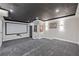 Finished basement movie room with tiered seating and projection screen at 5395 Lacosta Ln, Alpharetta, GA 30022