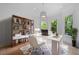 Well-lit office space features a large window, a bookshelf, and a modern desk at 5395 Lacosta Ln, Alpharetta, GA 30022