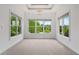 Bright, empty room featuring natural light streaming in through large windows overlooking greenery at 5395 Lacosta Ln, Alpharetta, GA 30022