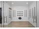 Walk-in wine cellar with glass doors and individual wine rack storage at 5395 Lacosta Ln, Alpharetta, GA 30022