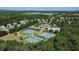 Community aerial view showcasing tennis courts, a pool, and beautiful green spaces, perfect for active living at 5510 Weddington Dr, Cumming, GA 30040