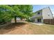 Spacious backyard with a large tree offering shade and a patio area at 5510 Weddington Dr, Cumming, GA 30040
