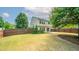 Large, fenced backyard with a well-maintained lawn and a concrete patio at 5510 Weddington Dr, Cumming, GA 30040