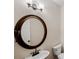 Bathroom featuring a round mirror, stylish sink and hardware at 5510 Weddington Dr, Cumming, GA 30040