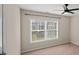 Bedroom featuring a ceiling fan, bright windows and neutral walls at 5510 Weddington Dr, Cumming, GA 30040