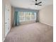 This bedroom features a ceiling fan, a bright window and neutral walls at 5510 Weddington Dr, Cumming, GA 30040