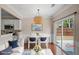 Bright dining room with stylish light fixture, access to the backyard, and modern furnishings at 5510 Weddington Dr, Cumming, GA 30040