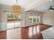 Elegant dining room with a modern chandelier, sliding glass doors to the patio, and hardwood floors at 5510 Weddington Dr, Cumming, GA 30040