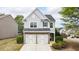 Beautiful home featuring brick and siding accents, a two-car garage, and mature landscaping at 5510 Weddington Dr, Cumming, GA 30040