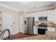 Well-equipped kitchen with stainless steel appliances, granite countertops, and ample cabinet space at 5510 Weddington Dr, Cumming, GA 30040