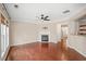 Bright living room featuring hardwood floors, a fireplace, and an open layout with plenty of natural light at 5510 Weddington Dr, Cumming, GA 30040