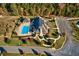 Aerial view of community clubhouse, pool, and landscaped grounds, showcasing a luxurious and well-maintained environment at 4435 Pebble Rock Dr, Cumming, GA 30041