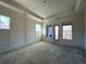 Spacious bedroom with tray ceiling, large windows, and paneled accent wall at 4435 Pebble Rock Dr, Cumming, GA 30041