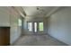 Bedroom featuring tray ceilings, large windows and a ceiling fan at 4435 Pebble Rock Dr, Cumming, GA 30041